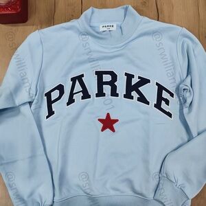 PARKE Women's Sky Blue Mock Neck Sweatshirt With A Red Star